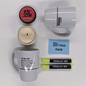 Two Fringe mugs, two highlighters, one candle, and a Next Stage pass