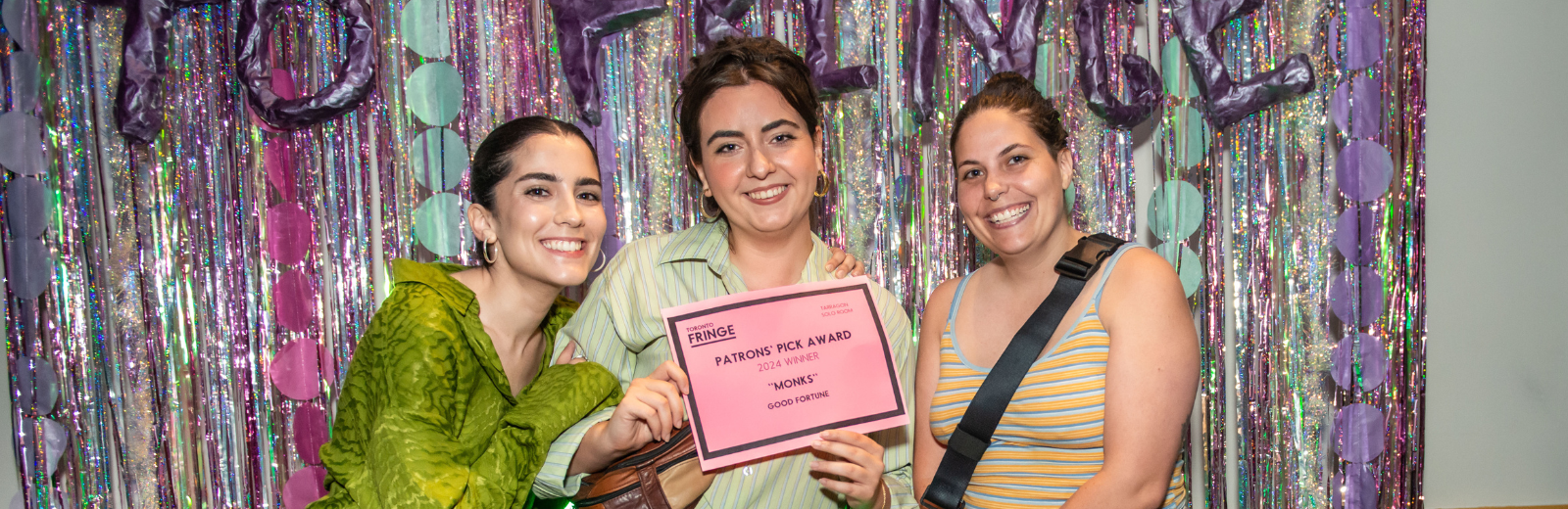 The producers of MONKS hold up their Patrons' Pick award