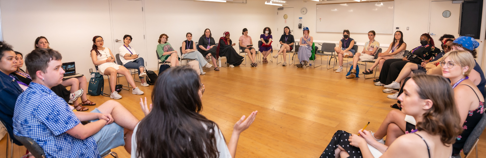 TENT participants sit in a circle and discuss