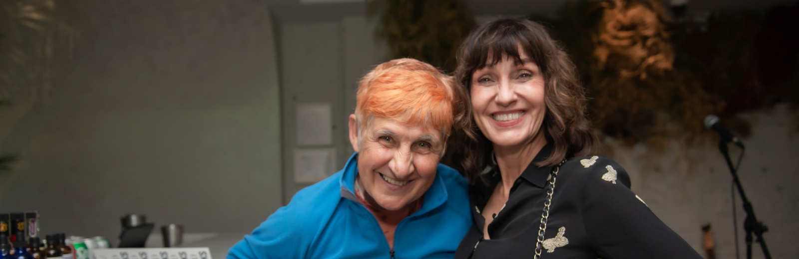 Two donors stand together and smile at the camera